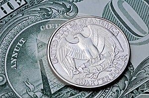 US coin quarter dollar on one dollar bill.