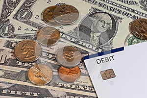 US coins and debit card on US cuurency background. top view. financial and banking concept.
