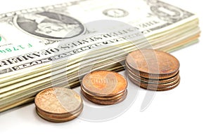 Us coins and dollar bills on white background.