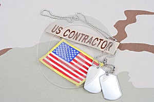 US CONTRACTOR branch tape with dog tags and flag patch on desert camouflage uniform