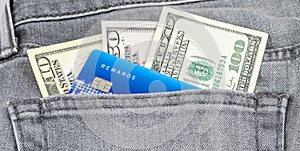 US dollar banknote and credit card in the grey jean pocket