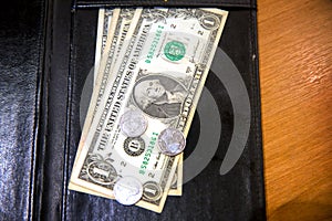 US dollar banknote tips in leather black bill reciept.