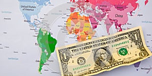 US dollar banknotes on globe world map, American investment and trading