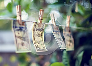US dollar banknotes hanging on rope money laundering concept
