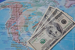 US dollar banknotes on world globe map