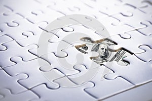 US Dollar behind jigsaw. Business and Financial concept. Marketing and currency theme