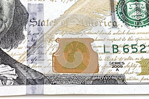 US 100 dollar bill close up. Hundred dollars bill fragment on macro. Fragment of bills close-up. New sample money