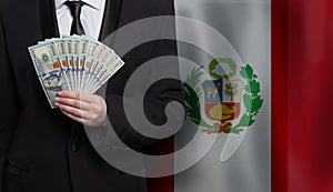 US dollar bills money banknotes in hand against flag of Peru background