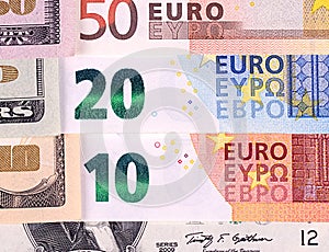 US dollar and euro bills abstract background.