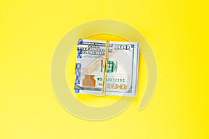 US dollar money cash on yellow background. American Dollars 100 banknote