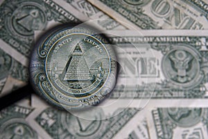 US dollar viewed through a magnifying glass, close up detail of the pyramid. Masonic symbols.