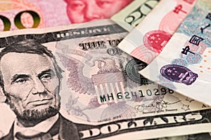 US Dollar and Yuan Renminbi China currency banknotes close up image. USD vs RMB