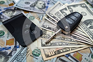 us dollars banknotes and car keys or remote control for duy rent insurence auto