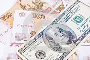 Us dollars banknotes lying over russian rubles background, financial crisis and choosing currency for savings, ruble devaluation