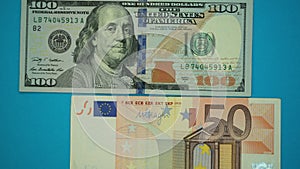 Us dollars and euro banknotes on blue