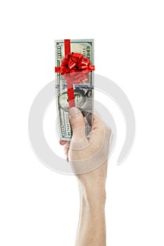 US dollars gift profit. Money cash with red ribbon and bow in man hand isolated on white background.