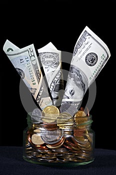 US dollars in a glass can