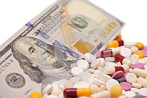 US Dollars with medicine pills. High Cost of Medicine and Healthcare