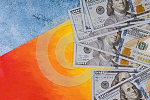 US dollars money on blue and orange background