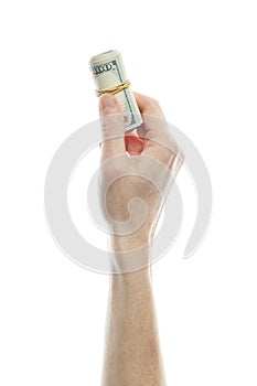 US dollars representing investments for wealth and riches. Roll of 100 note in mans hand isolated on white background