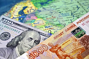 US dollars and russian rubles on map of Russia and Ukraine