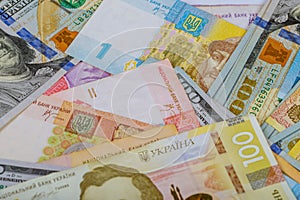 US dollars and ukrainian hryvnia, banknotes background
