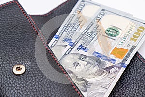 Us dollars in a wallet, saving money and wealth concept