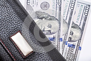 Us dollars in a wallet, saving money and wealth concept