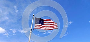 US Flag against blue sky