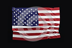 US Flag. American flag rippled on black background.