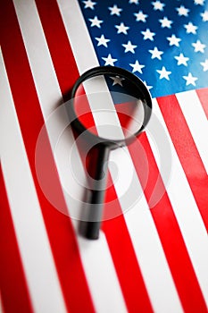 US flag looking through a magnifying glass. Study of the history and culture of the country of the United States. The concept of