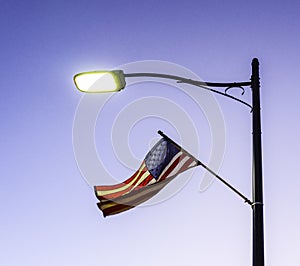 US flag on a pole of a street light