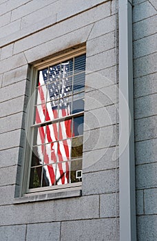 US Flag seen reflecting from a Harvard University window.