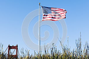 US Flag and Top of one Tower Golden Gate Bridge Sa