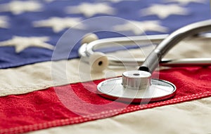 US health. Medical stethoscope on a USA flag, closeup view
