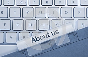 About us - Inscription on Blue Keyboard Key