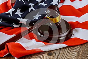 US legal office with USA lawyers in the judge& x27;s gavel on American flag wooden table