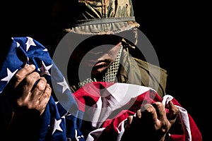 US Marine Vietnam War holding American flag.