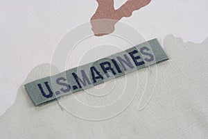 US MARINES branch tape with dog tags on desert camouflage uniform