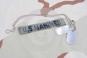 US MARINES branch tape with dog tags on desert camouflage uniform