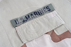 US MARINES branch tape with dog tags on desert camouflage uniform