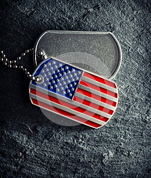 US military soldier\'s dog tags, rough and worn with blank space for text, and in the shape of the American flag.