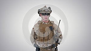 US Military Soldier in Uniform Reports on gradient background.