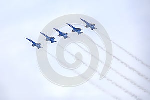 US Navy Blue Angels Hornet Fighter Jets Flying In Formation With Smoke Trails During An Air Show Performance