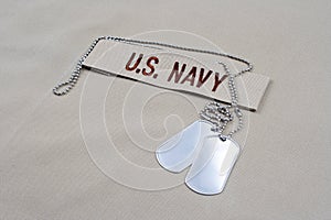 US NAVY branch tape with dog tags on desert camouflage uniform