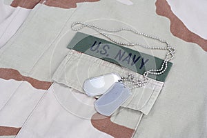 US NAVY branch tape with dog tags with dog tags on desert camouflage uniform