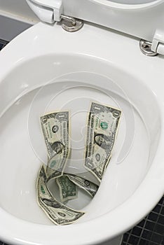 US one dollar bills flushed down the toilet, toilet paper, trash concept