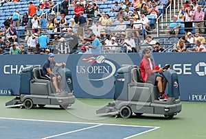 US Open cleaning crew drying tennis court after rain delay at Louis Armstrong Stadium at Billie Jean King National Tennis Center