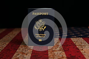 US Passport standing on rustic American Flag with black background