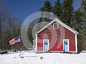 US schoolhouse with flag